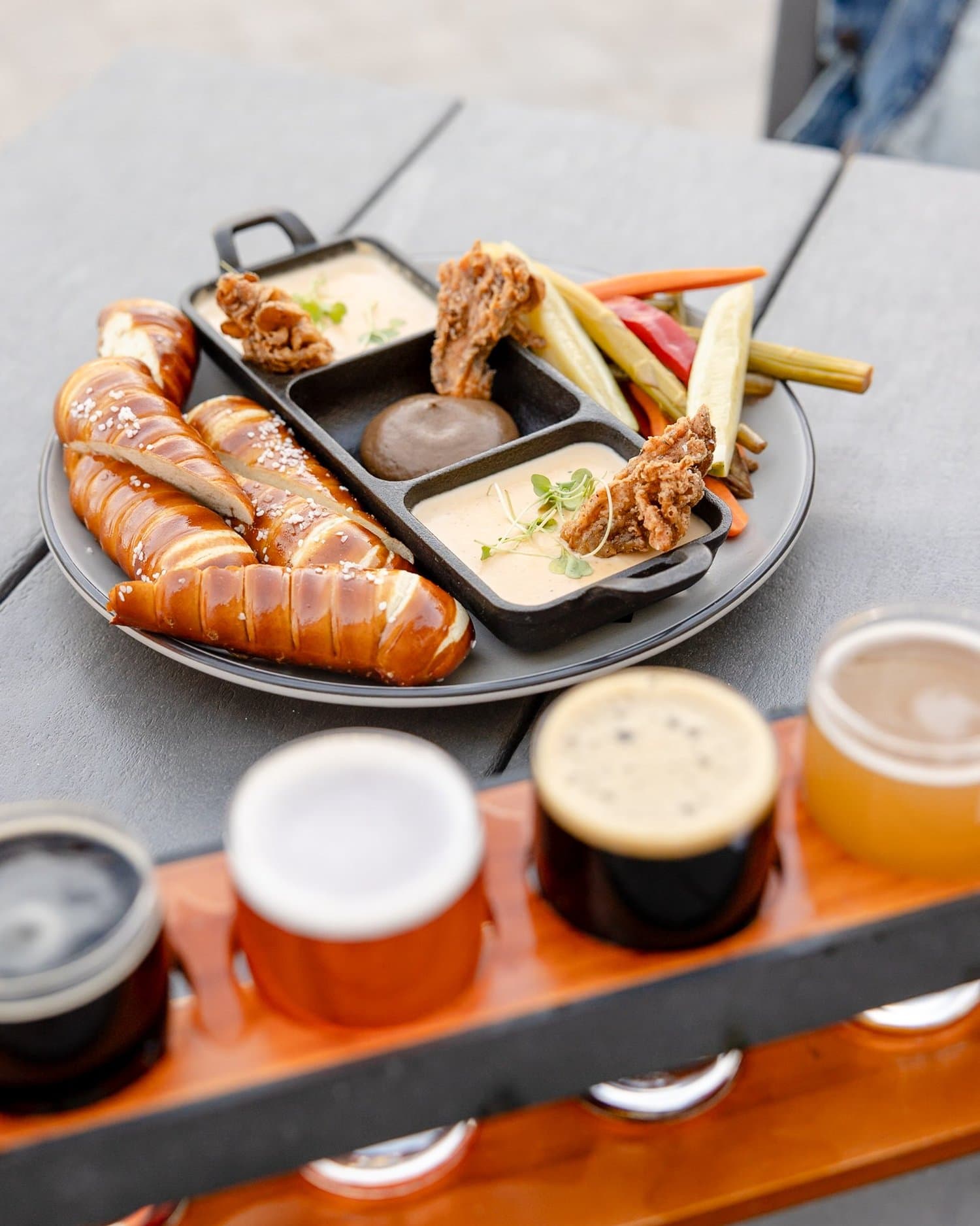 A beer flight served with warm pretzels