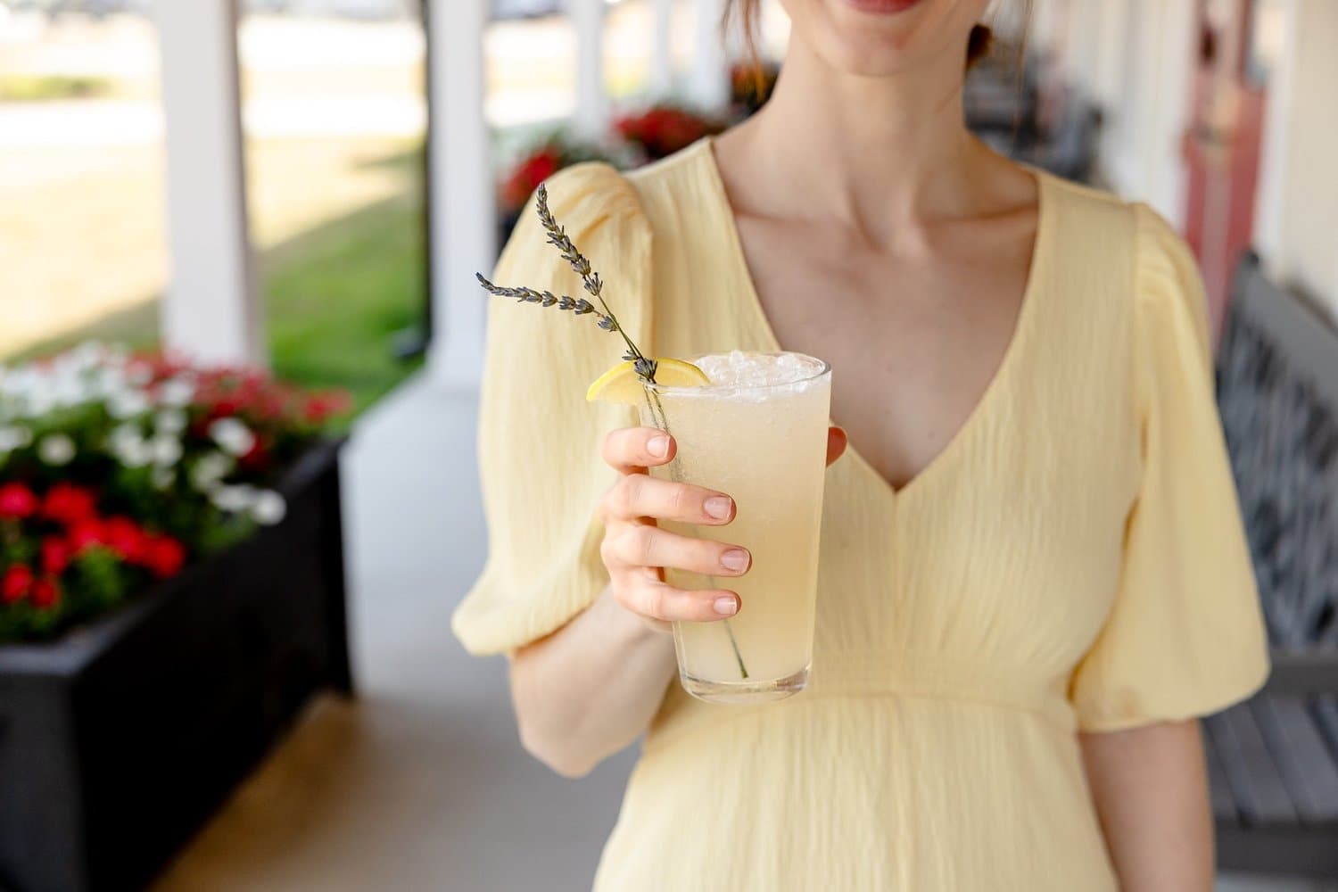 A guest enjoying a cocktail on the porch