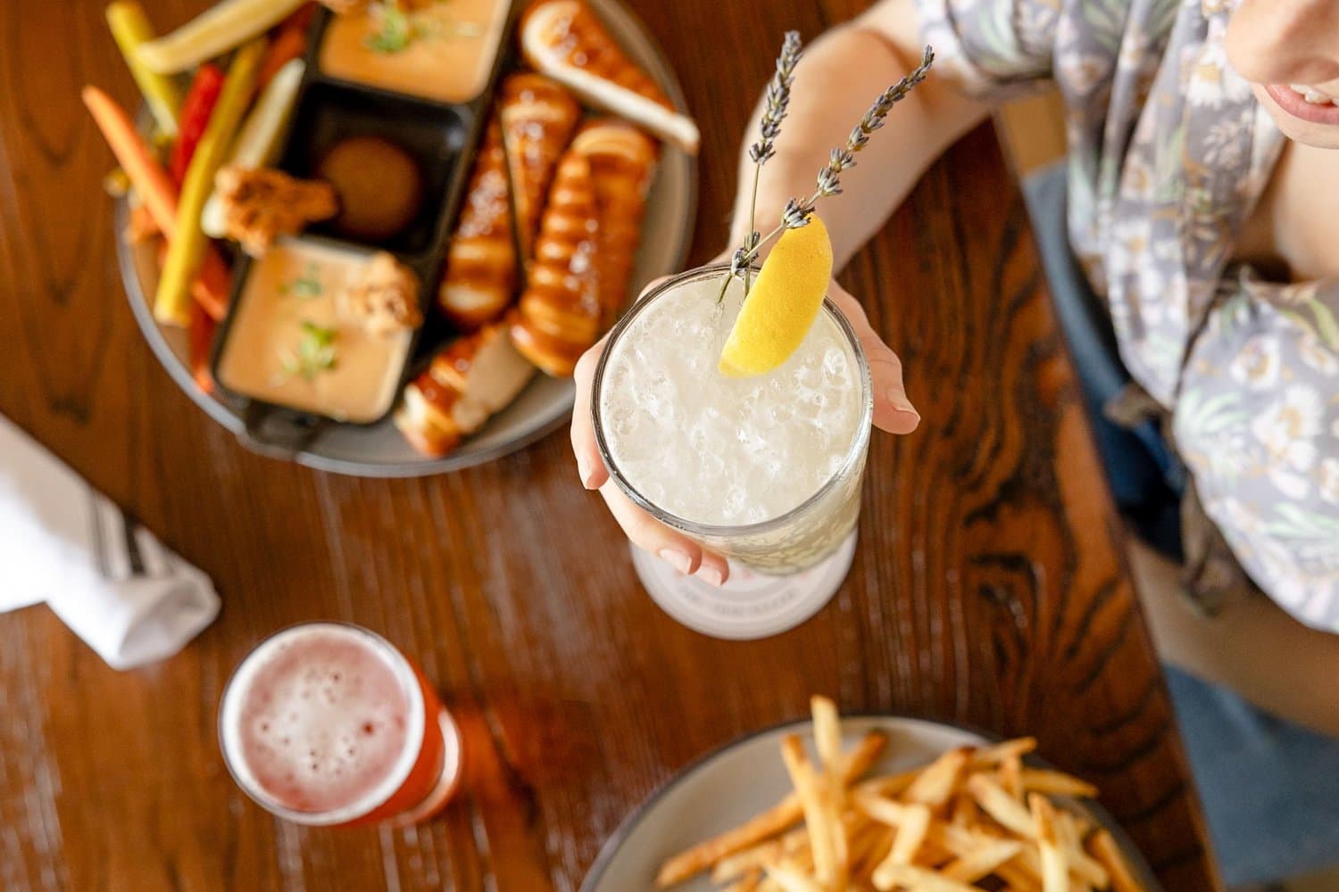 Food, beer, and cocktails shared around a Hidden Wit table