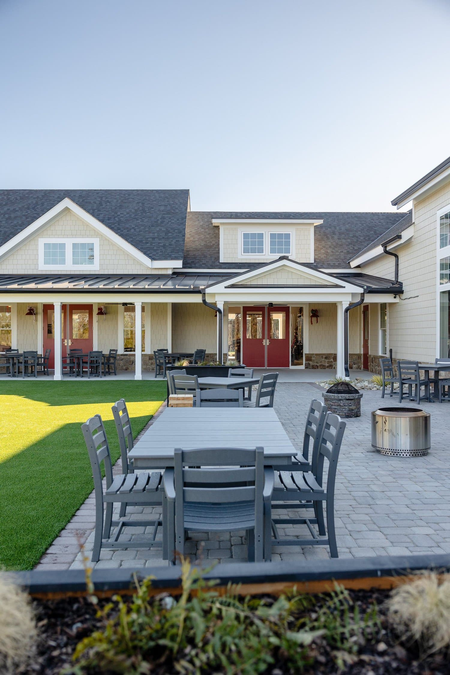 Outdoor dining tables beside the lawn at Hidden Wit