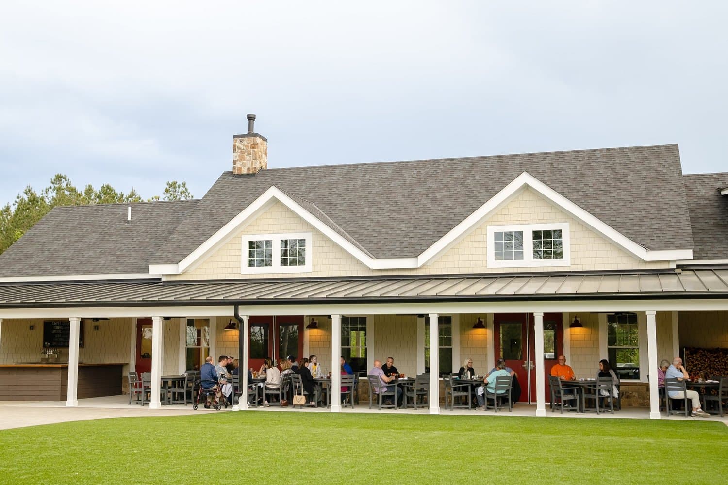 Guests gathering together on the covered porch at Hidden Wit