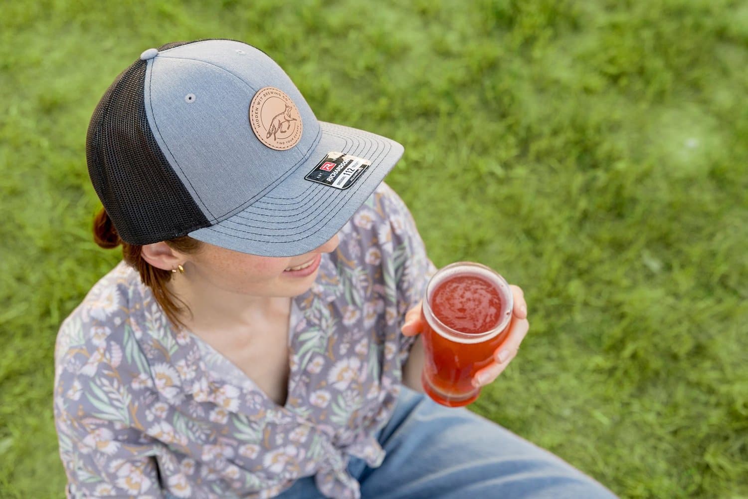 A guest enjoying a fresh beer outdoors at Hidden Wit